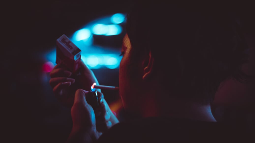 Man Lighting Up a Cigarette during Nighttime in Tilt Shift Lens Photograhy