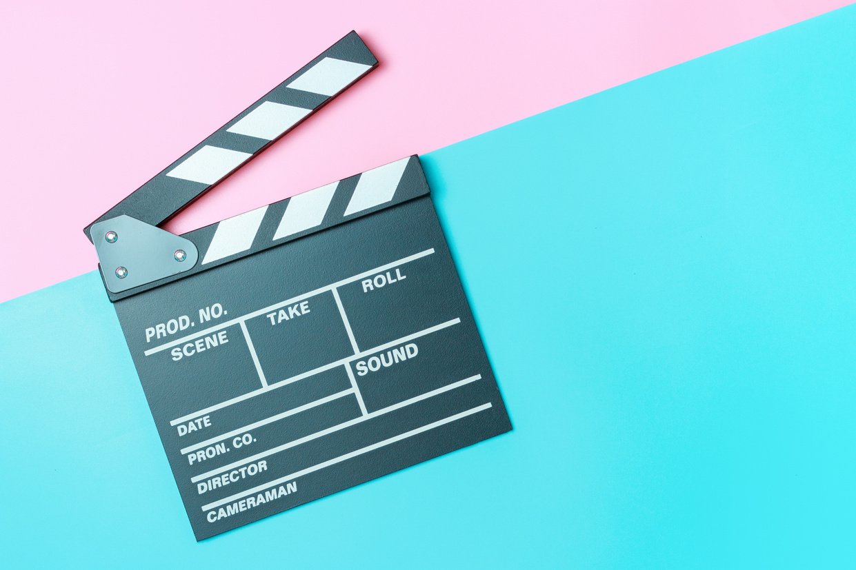 The Clapperboard on Pink and Blue Background Close-up, Top View.